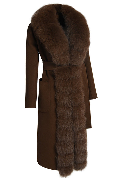This elegant brown double-faced cashmere coat offers structure and softness, with a cinched waist belt and plush genuine brown fox fur trim for added warmth and sophistication.