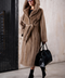 Light brown long mink fur coat with hood and belt at the waist, showcasing luxury and elegance.
