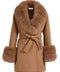 A woman wearing a chic short camel cashmere coat, featuring luxurious fox fur accents and elegant gold buttons, perfect for a refined and stylish look.